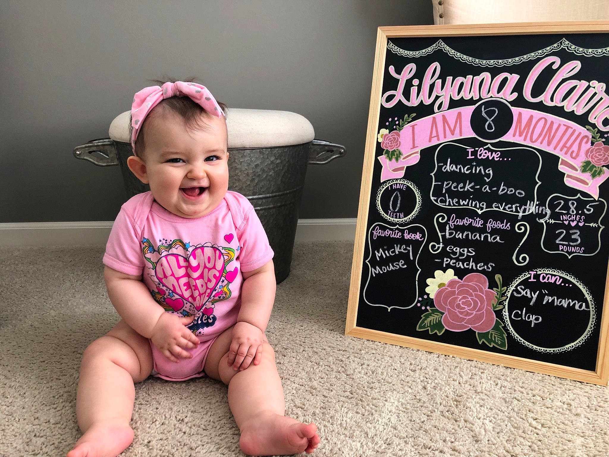 Lilyana joined the competition — help win amazing prizes! baby, baby_toddler_clothing, blackboard, child, joy, party, person, photo_caption, photography, pink, room, sitting, t_shirt, toddler