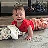 baby, child, infant, smiling, happy, tummy_time, portrait, indoors, blanket, red_shirt, pink_pants, floor, carpet, living_room, gaming_controller, virtual_reality_headset, electronics, cables, cozy, family_photo