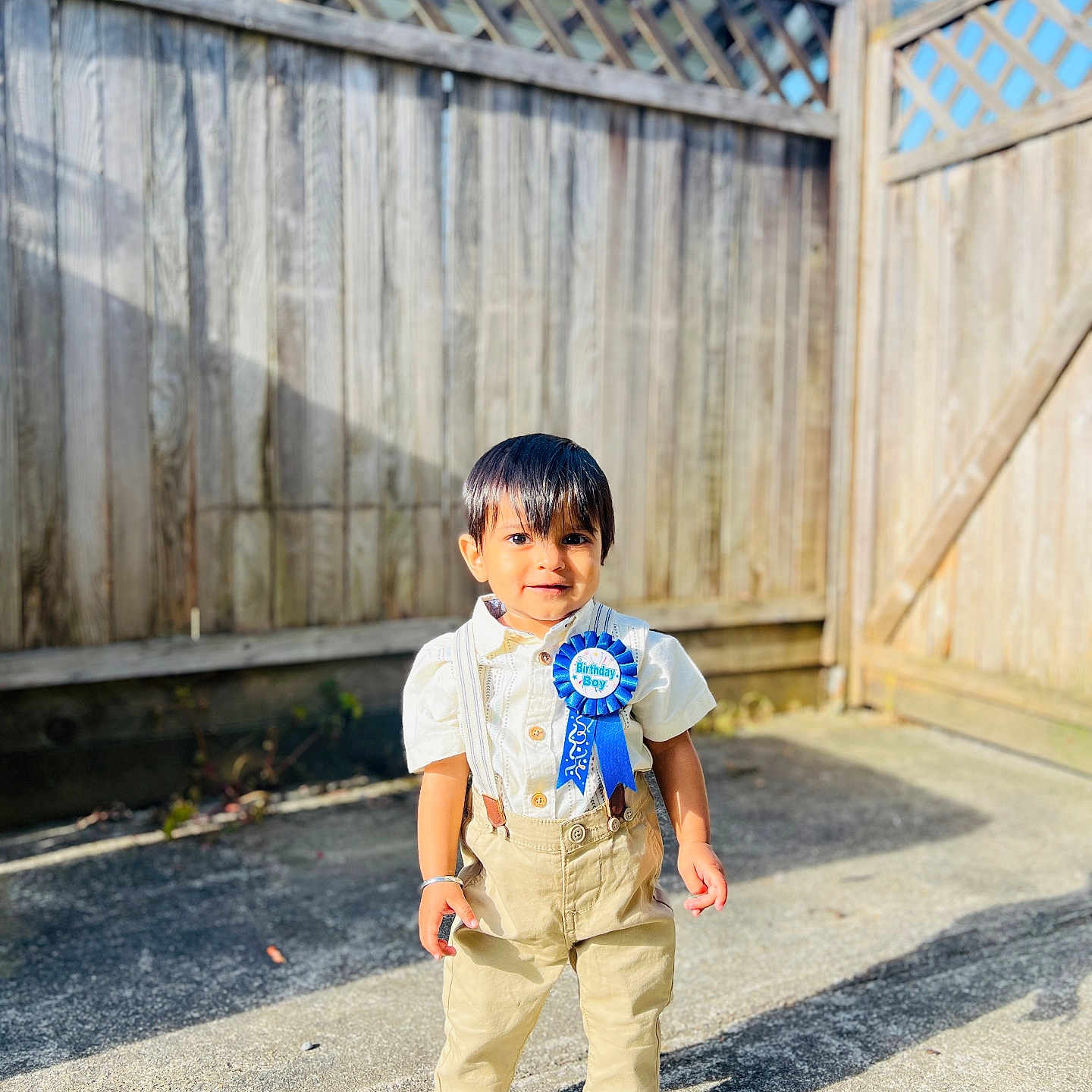 Eevaan joined the competition — help win amazing prizes! birthday_boy, boy, celebration, child, concrete, cute, fence, happy, outdoor, pants, portrait, ribbon, shadow, shirt, shoes, smile, standing, sunlight, suspenders, young