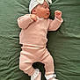 baby, sleeping, pink_outfit, headband, bow, green_blanket, shoes, minnie_mouse, frilly_socks, infant, cute, cozy, soft_texture, lying_down, peaceful, child, apparel, portrait, indoors, rest