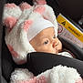 Felicia participe au concours pour gagner de l'argent avec cette photo : baby, infant, car_seat, hat, pink, white, fluffy_clothing, warm, child, cute, side_view, warning_label, seatbelt, closeup, portrait, indoors, soft_texture, headwear, safety, newborn
