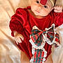 adorable, baby, blanket, bow, child, cute, fashion, footwear, headband, holiday, indoors, infant, lace, lying_down, newborn, person, plaid, portrait, red_dress, soft_texture