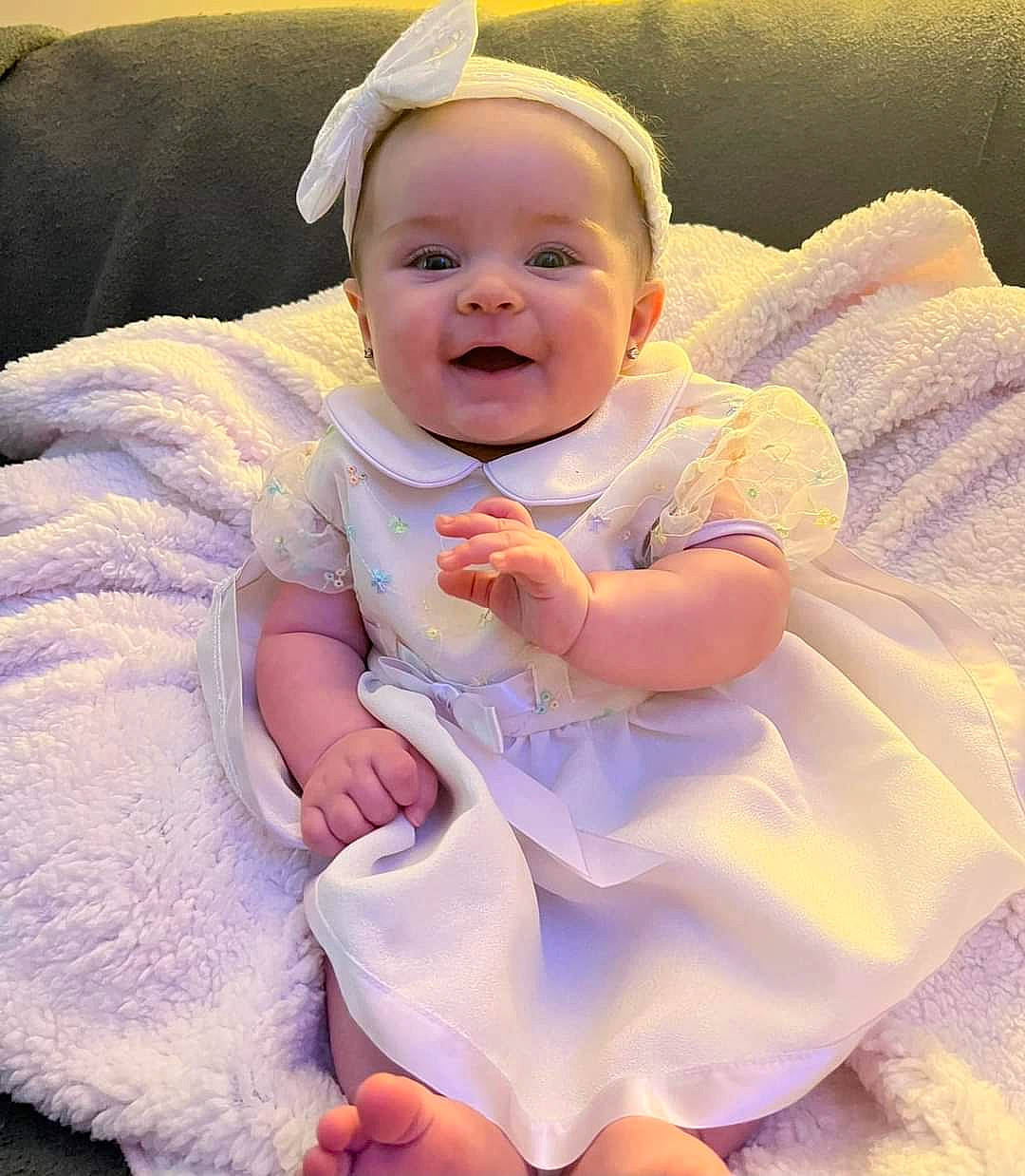 Oaklyn is registered to the contest to win money with this photo: baby, baby_toddler_clothing, beauty, cheek, child, comfort, dress, eye, finger, flash_photography, gesture, happy, iris, person, pink, purple, skin, sleeve, smile, toddler