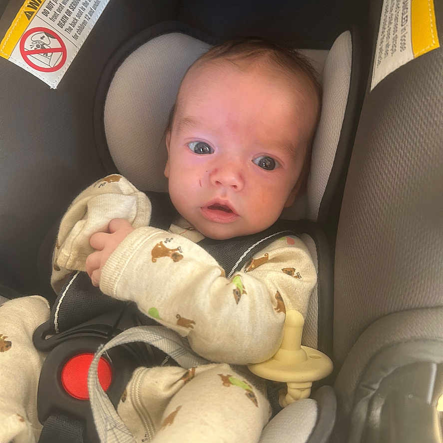 Waylyn is registered to the contest to win money with this photo: baby, bodypart, car, car_interior, carseat, crib, cushion, face, finger, furniture, hand, head, homedecor, infantbed, newborn, person, photography, portrait, transportation, vehicle