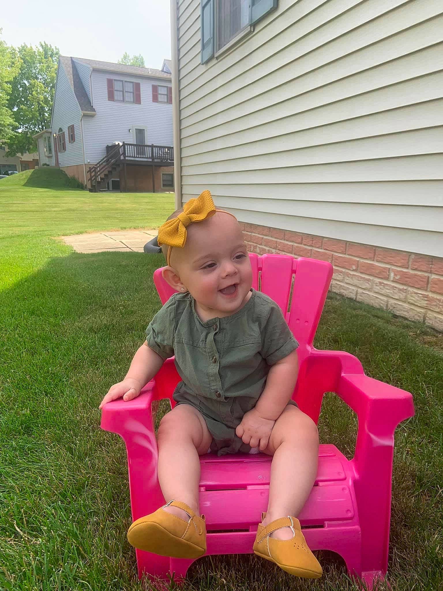 Ava joined the competition — help win amazing prizes! baby_toddler_clothing, fun, grass, happy, hat, lap, lawn, leisure, magenta, person, pink, plant, recreation, shorts, siding, sitting, sky, smile, toddler, tree