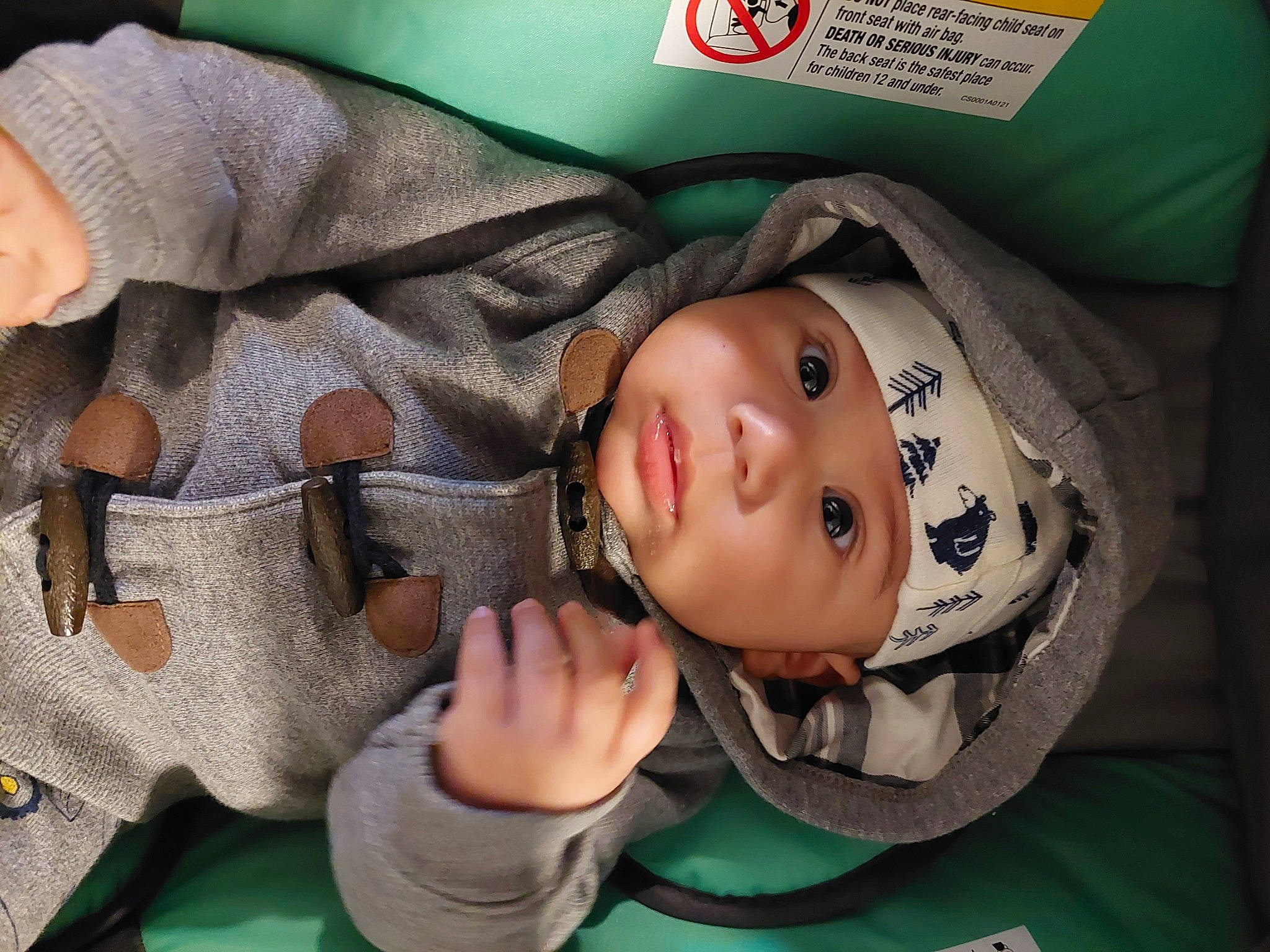 Evan is registered to the contest to win money with this photo: baby, baby_products, baby_toddler_clothing, cheek, child, comfort, eyelash, fun, gesture, green, happy, hat, headwear, mouth, nose, person, sitting, skin, sleeve, smile