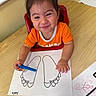 Anelia is registered to the contest to win money with this photo: artwork, baby, cartoon, child, coloring, crayon, creative, drawing, girl, happy, high_chair, indoor, orange_shirt, paper, pigtails, playtime, portrait, smiling, table, toddler