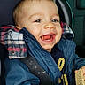 toddler, child, smiling, happy, car_seat, seatbelt, blue_jacket, snack, wafer, indoor, portrait, cute, baby, clothing, hands, face, head, car_interior, window, seat