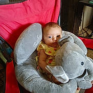 Myralyn joined the competition — help win amazing prizes! baby, baby_seat, blue_eyes, child, comfort, cushion, cute, elephant, expression, face, furniture, indoors, infant, person, plush_toy, red_chair, seated, soft_toy, strawberry_print, yellow_clothing