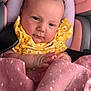baby, infant, car_seat, blanket, yellow_clothing, floral_pattern, face, hands, pink, cute, child, portrait, indoor, soft, newborn, expression, seated, comfort, closeup, young