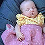 Chayanna is registered to the contest to win money with this photo: baby, sleeping, blanket, pink, yellow, floral, ruffles, cushion, rest, peaceful, infant, child, soft, cute, hand, portrait, indoors, clothing, nap, relaxing