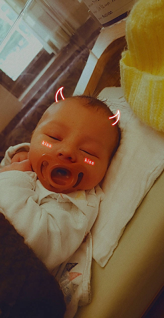 Levi is registered to the contest to win money with this photo: baby, baby_toddler_clothing, cheek, child, chin, comfort, ear, eye, eyelash, finger, fruit, head, linens, lip, mouth, nose, orange, person, skin, sleeve