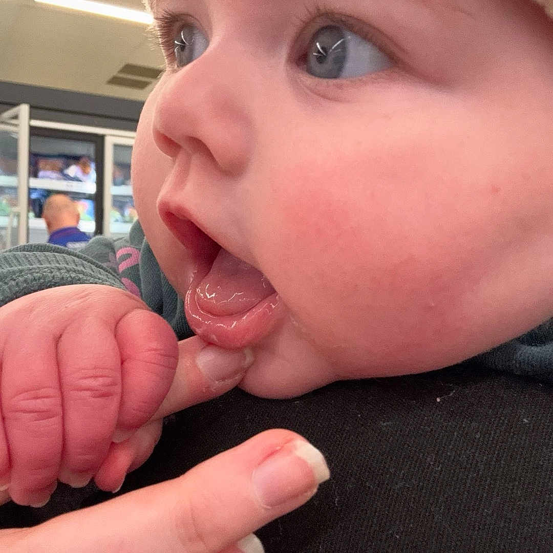 Hallie is registered to the contest to win money with this photo: baby, bodypart, cap, clothing, coat, cream, dessert, face, finger, food, hand, hat, head, icecream, jacket, mouth, person, photography, portrait, tongue