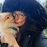Alpha participe au concours pour gagner de l'argent avec cette photo : affection, black_coat, closeup, dog, face, fluffy_dog, fur_hood, glasses, holding, kiss, long_hair, nature, outdoor, pet, pomeranian, portrait, puppy, smile, winter_clothing, woman