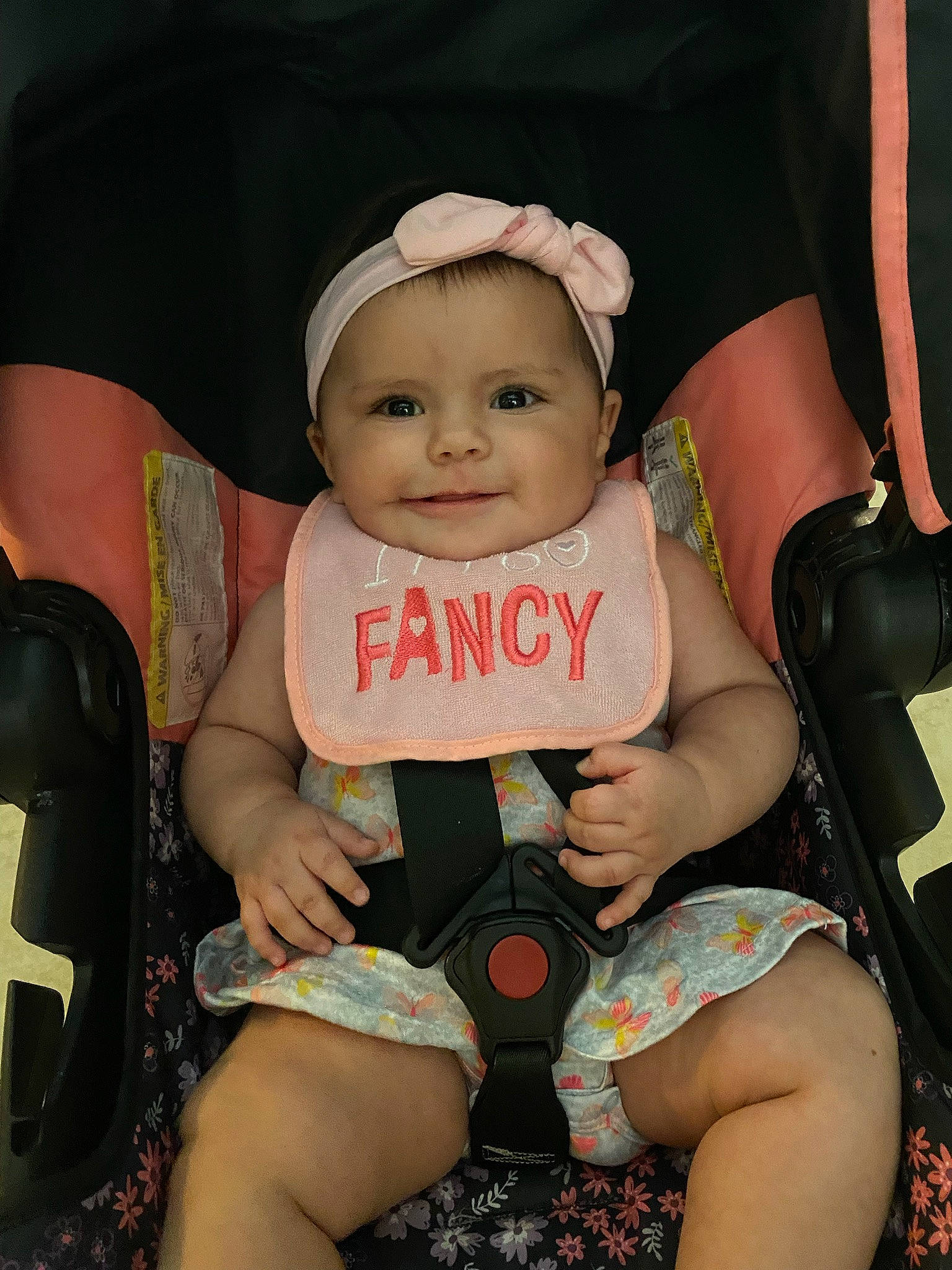 Delilah is registered to the contest to win money with this photo: baby, baby_carriage, baby_products, baby_toddler_clothing, black, chair, fashion, finger, flash_photography, fun, happy, headwear, human_leg, joy, leg, nail, person, pink, sitting, skin
