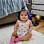 toddler, child, indoor, sitting, pink_socks, white_dress, hearts_pattern, pony_tail, floor_mat, wooden_floor, pepsi_box, slippers, cabinet, bed, blanket, cute, portrait, young_child, baby, home