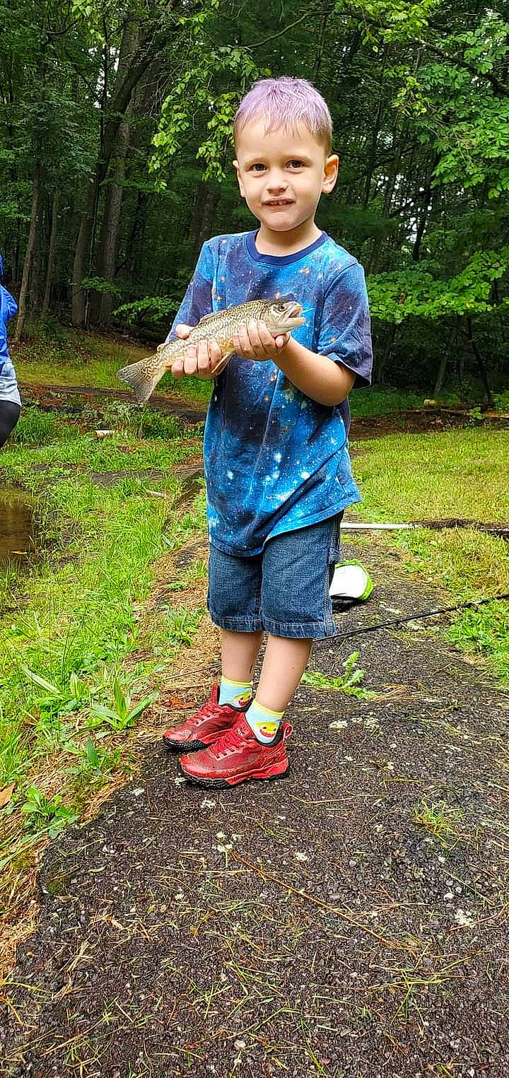 Axle is registered to the contest to win money with this photo: botany, child, denim, electric_blue, fish, fun, grass, hat, joy, leaf, leisure, people_in_nature, person, plant, recreation, shorts, sleeve, soil, summer, t_shirt