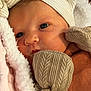 newborn, baby, face, mittens, hat, blanket, close_up, portrait, soft_texture, warm_clothing, infant, sleepwear, cute, cozy, person, skin, headwear, resting, indoors, child