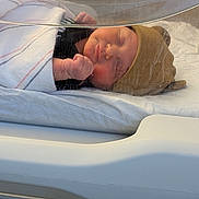 Savannah is registered to the contest to win money with this photo: newborn, baby, sleeping, hospital, bassinet, blanket, hat, face, infant, cute, wrapped, clothing, person, bed, resting, indoors, healthcare, peaceful, small, child
