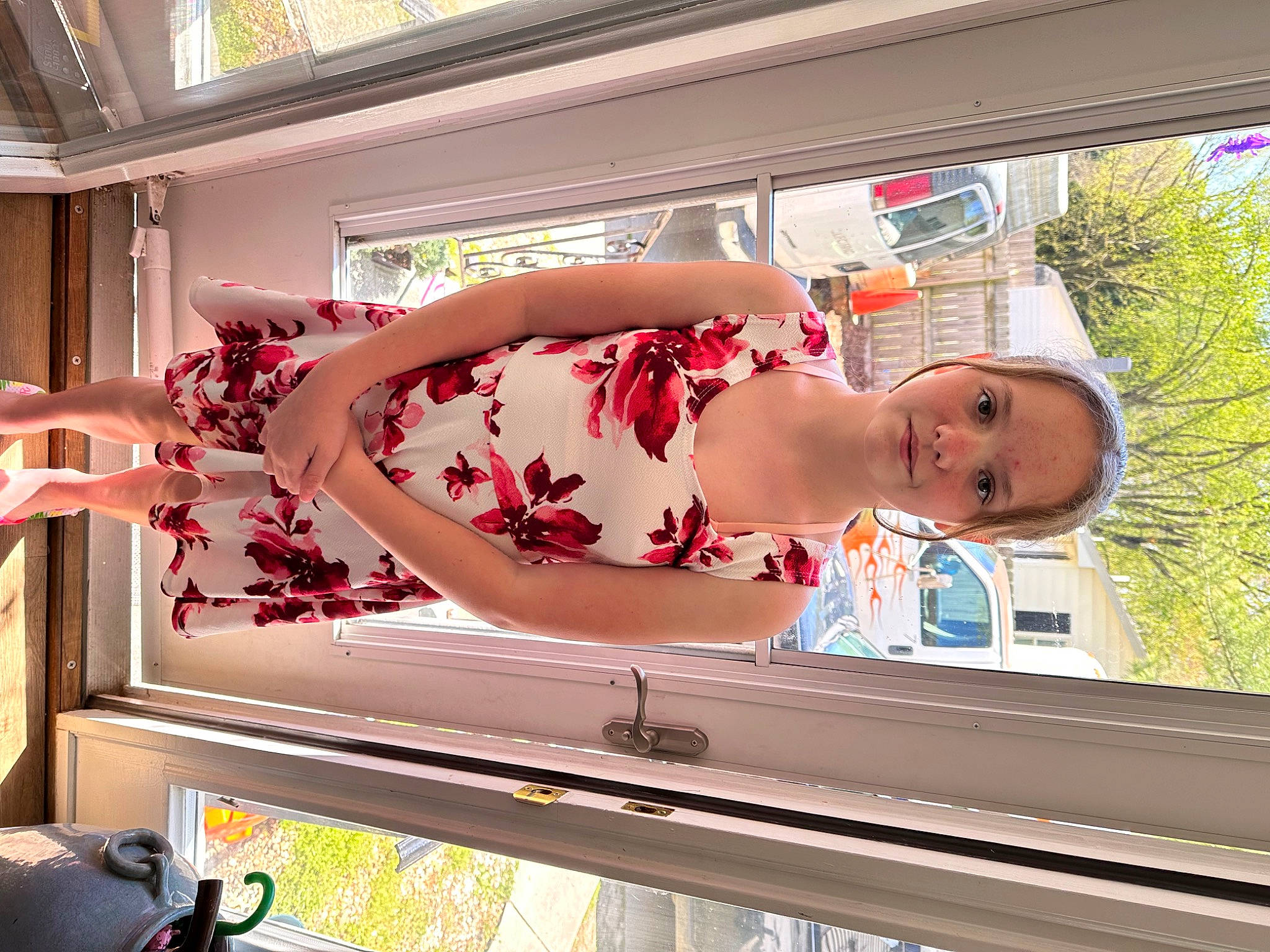 Alexis is registered to the contest to win money with this photo: advertising, carmine, curtain, dress, elbow, flesh, flower, fun, human_leg, leisure, magenta, person, plant, thigh, tree, window