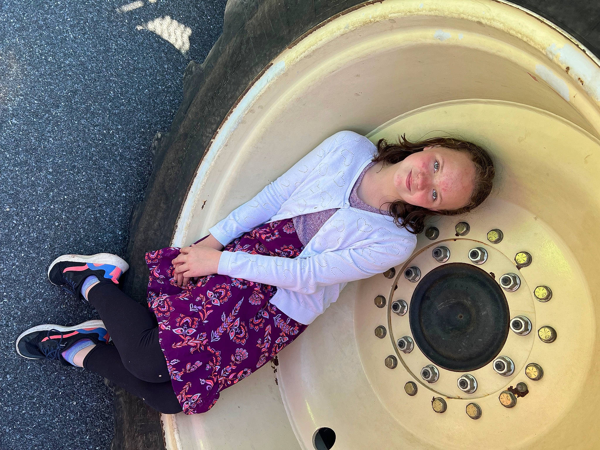 Alexis is registered to the contest to win money with this photo: auto_part, automotive_design, automotive_tire, automotive_wheel_system, child, circle, comfort, fun, happy, hat, joy, machine, magenta, pattern, person, purple, rim, service, thigh, toddler