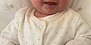Ella is registered to the contest to win money with this photo: baby, bodypart, clothing, couch, cushion, face, finger, furniture, hand, happy, head, homedecor, longsleeve, newborn, pants, person, photography, portrait, sleeve, smile