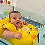Abby participe au concours pour gagner de l'argent avec cette photo : baby, bathtub, water, yellow_float, duck_float, smiling, happy, child, toy, indoor, face, blue_eyes, floating, skin, wet_hair, bathroom, infant, cute, playful, expression