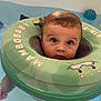 Abby a rejoint le concours — aidez-le/la à gagner de superbes lots ! baby, infant, water, pool, floatation_ring, mambobaby, child, swimming, blue_eyes, wet_hair, toy, bath, water_toys, floating, cute, indoors, skin, face, safety, child_in_water