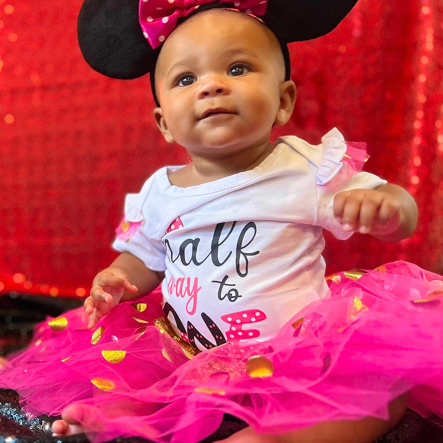 Alayah is registered to the contest to win money with this photo: accessories, baby, bodypart, cap, clothing, costume, dress, face, finger, formalwear, hand, hat, head, person, photography, portrait, purple, sitting, skirt, t_shirt