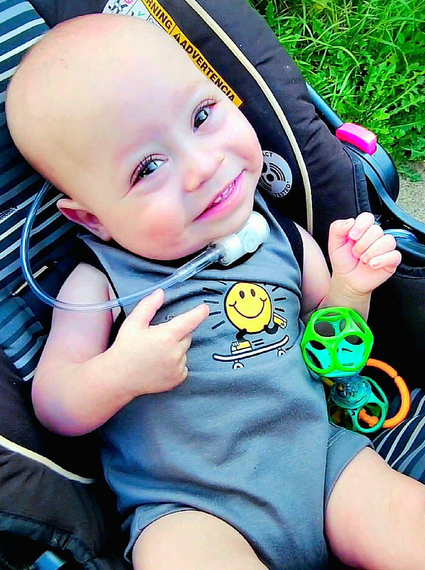 Blythe is registered to the contest to win money with this photo: baby, baby_toddler_clothing, blue, child, cool, facial_expression, finger, grass, green, hand, happy, headgear, person, photograph, plant, product, skin, sleeve, smile, toddler