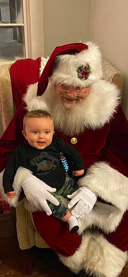 Colton joined the competition — help win amazing prizes! baby, beard, christmas, costume_hat, event, facial_hair, fictional_character, fun, fur, happy, hat, head, holiday, human_body, lap, person, santa_claus, smile, toddler, tree