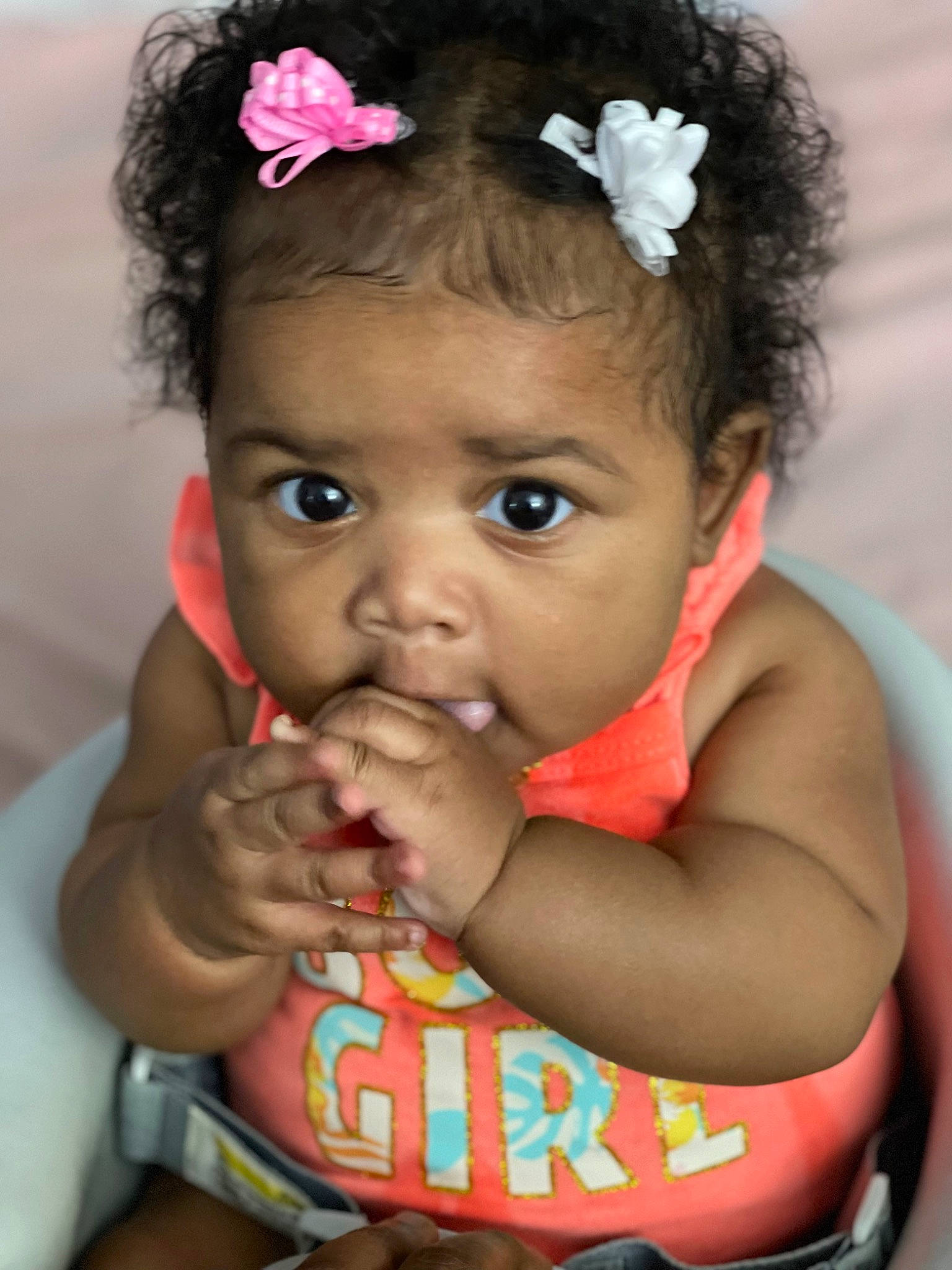 Joy is registered to the contest to win money with this photo: arm, baby_toddler_clothing, cheek, chin, eyebrow, eyelash, facial_expression, flower, hairstyle, happy, human, iris, lip, mouth, neck, nose, organ, person, pink, skin