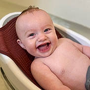 Reed joined the competition — help win amazing prizes! baby, smiling, bathtub, water_droplets, towel, happy, infant, skin, arm, torso, hair, child, cute, bath_time, chubby, person, indoor, closeup, expression, joy