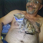 Squirrel Face joined the competition — help win amazing prizes! casual, comfort, companion, couch, cute, domestic_animal, feline, glasses, hairy_chest, happy, indoor, kitten, man, pet, relaxing, resting, shirtless, smile, tattoo, wristband