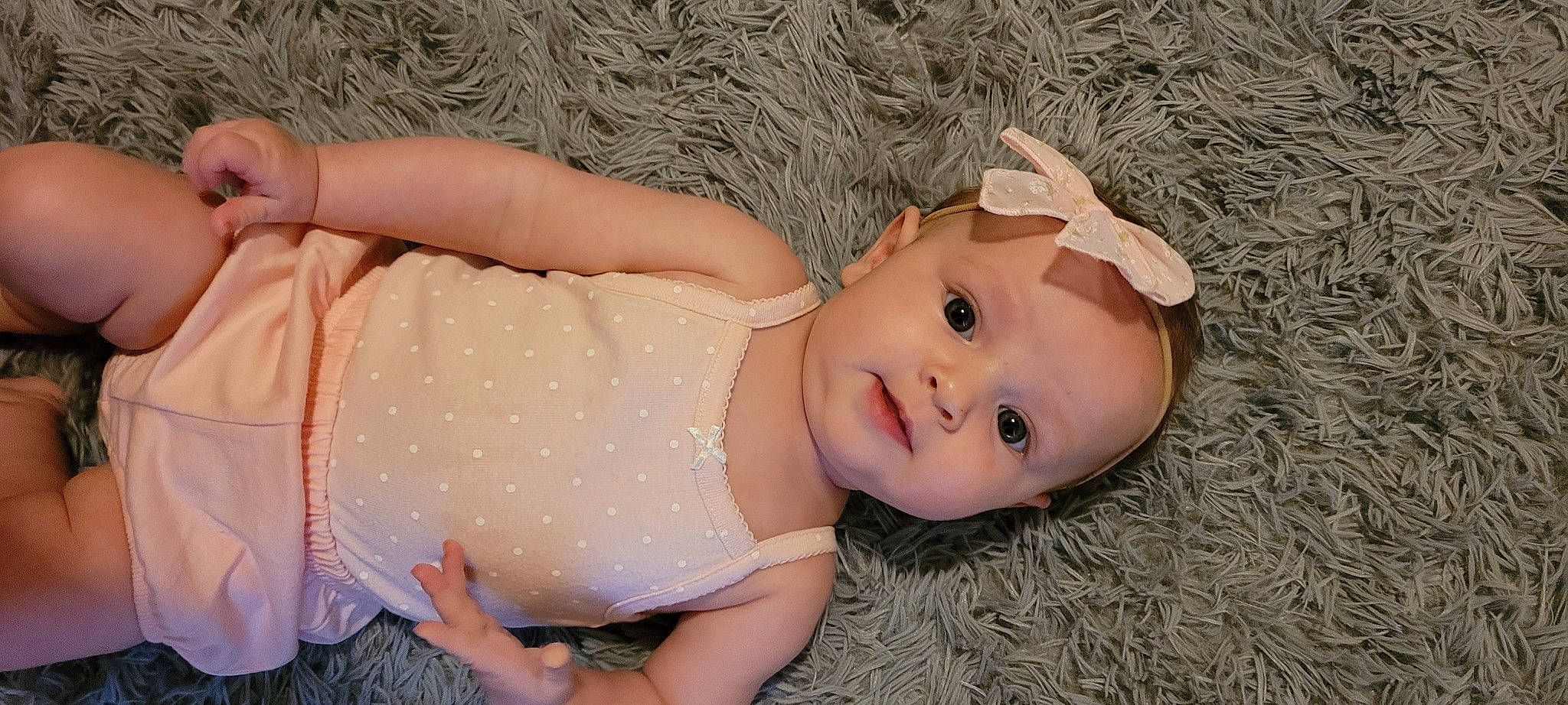 Katherine is registered to the contest to win money with this photo: baby_toddler_clothing, chest, dress, eye, facial_expression, fawn, grass, happy, head, headgear, human_body, leg, lip, person, plant, skin, thigh, toddler, toy, trunk