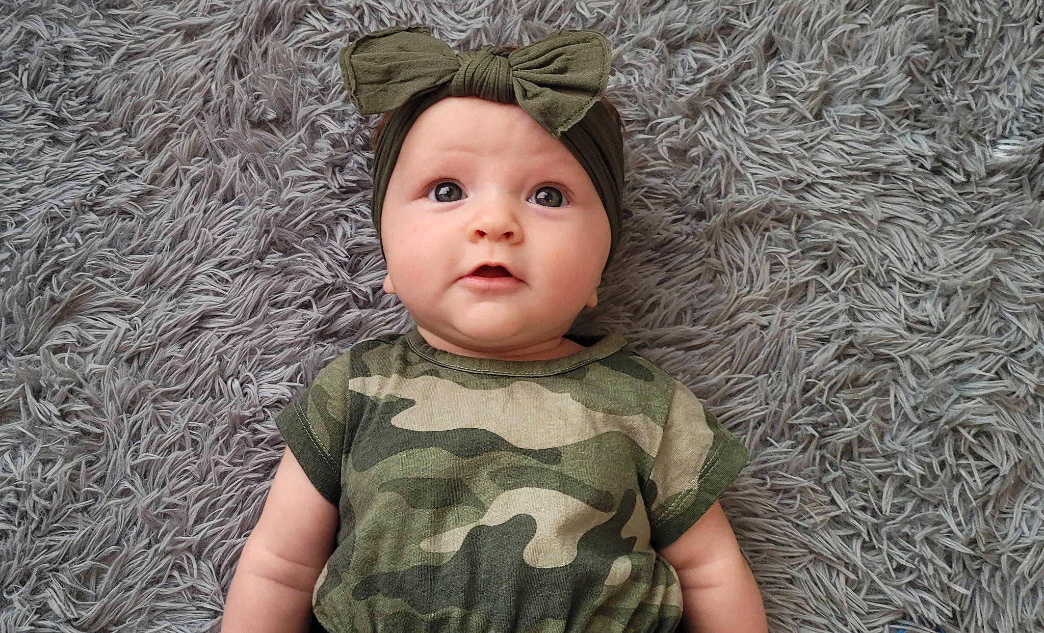 Katherine is registered to the contest to win money with this photo: baby, baby_toddler_clothing, cheek, child, clothing, eye, fashion_accessory, flash_photography, grass, happy, headwear, iris, nose, organ, pattern, people_in_nature, person, photograph, skin, sleeve