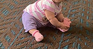 Promiseaity Flores is registered to the contest to win money with this photo: toddler, child, carpet, pink_socks, striped_shirt, purple_pants, indoor, smiling, baby, floor, wall, patterned_carpet, person, cute, young_child, sitting, holding, short_hair, playful, happy