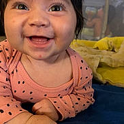 Promiseaity Flores is registered to the contest to win money with this photo: baby, smiling, infant, face, pink_clothing, polka_dots, hands, blanket, blue_blanket, yellow_blanket, crib, indoor, happy, cute, child, portrait, closeup, young_child, toddler, sleepwear