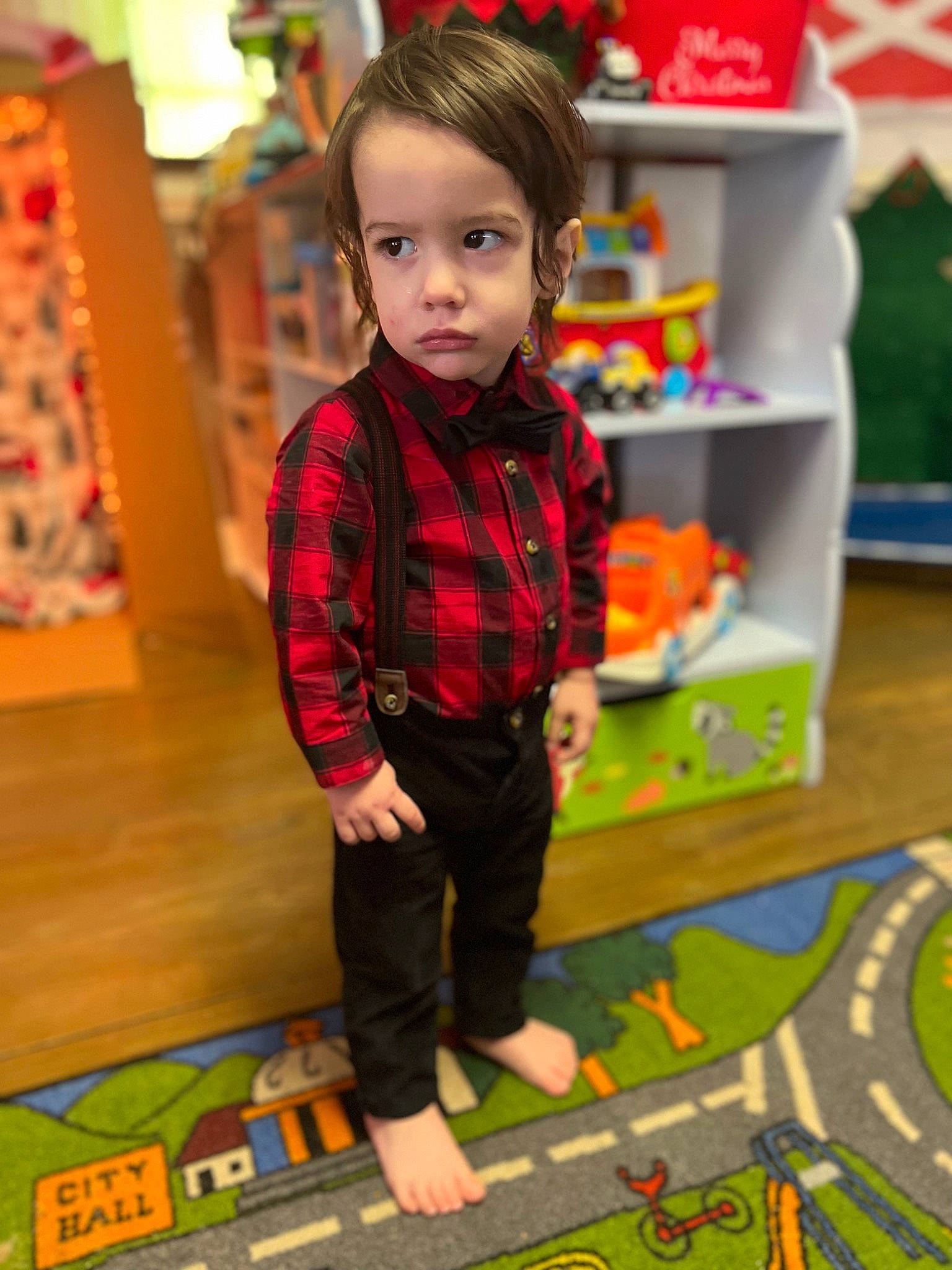 Braydon is registered to the contest to win money with this photo: child, floor, flooring, fun, green, leisure, pattern, person, plaid, play, recreation, room, shelf, sleeve, snapshot, standing, tartan, textile, toddler, toy