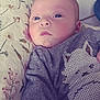 baby, infant, face, blue_eyes, pillow, floral_pattern, clothing, striped, cute, portrait, indoors, child, soft_light, expression, young, person, head, lying_down, cozy, baby_outfit
