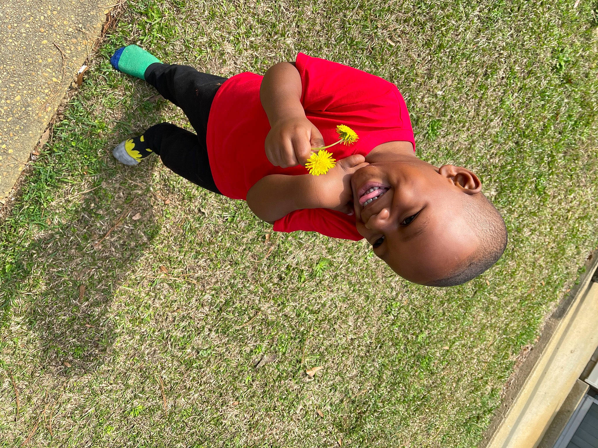 Kyson is registered to the contest to win money with this photo: balance, child, fun, grass, grassland, happy, human_leg, joy, knee, landscape, leisure, people_in_nature, person, physical_fitness, recreation, shorts, smile, soil, sportswear, thigh