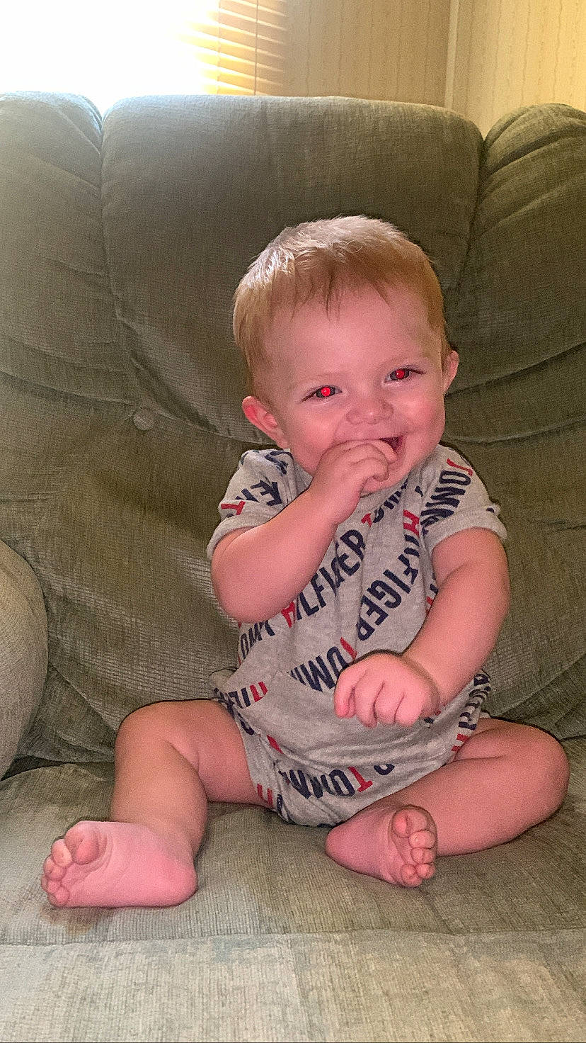 Kolson joined the competition — help win amazing prizes! baby_toddler_clothing, cheek, chin, comfort, couch, eye, face, finger, furniture, hair, hand, head, iris, joy, lap, leg, mouth, nose, person, skin