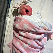 Raya is registered to the contest to win money with this photo: newborn, baby, infant, swaddled, blanket, pink, stars, yawning, headband, bow, hospital, bassinet, medical, tubes, cute, sleepy, child, soft, wrapped, portrait