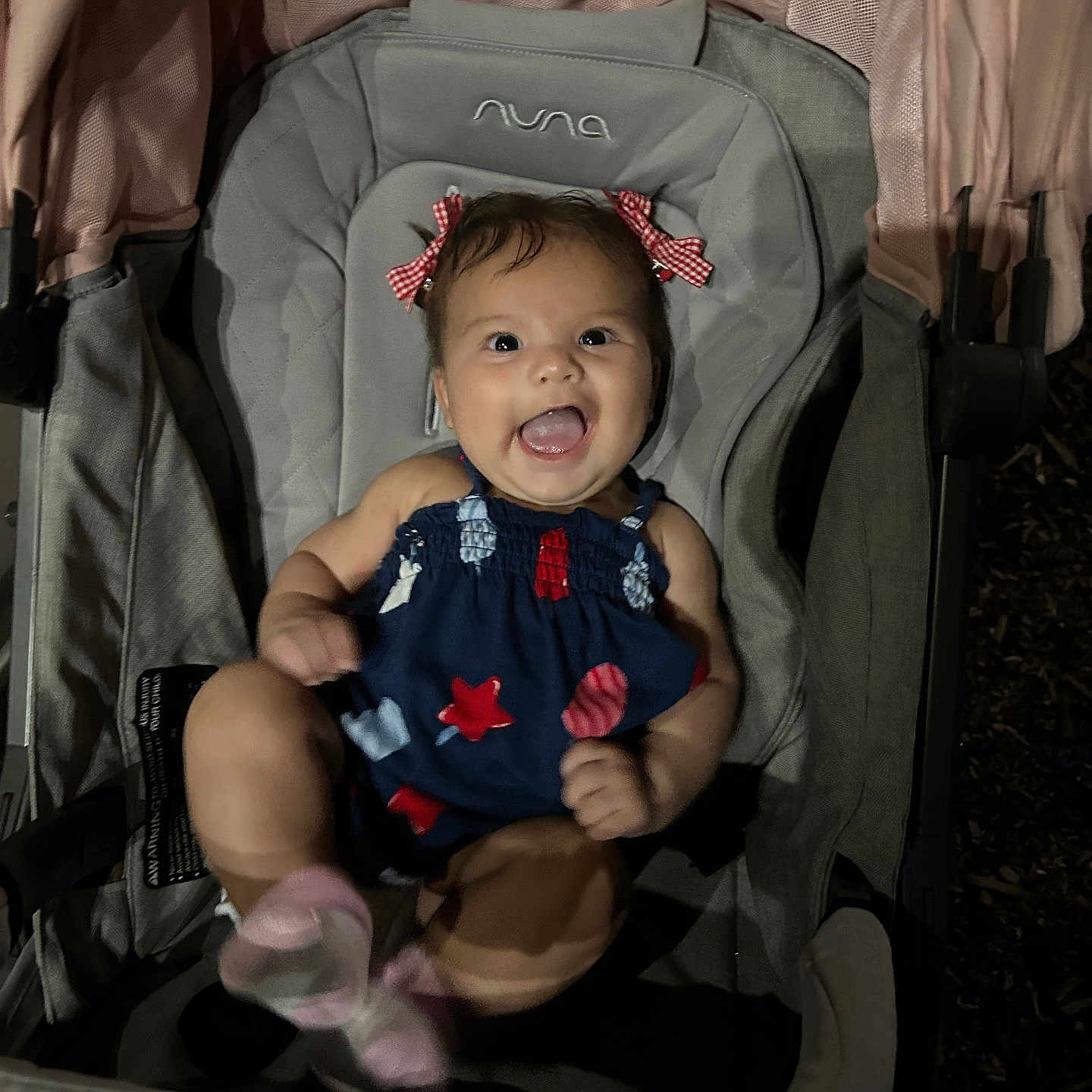 Isabella joined the competition — help win amazing prizes! baby, cheerful, child, clothing, cute, dress, fabric, hair_bows, happy, infant, joy, night, outdoor, person, pink_socks, playful, seat, small_child, smiling, stroller