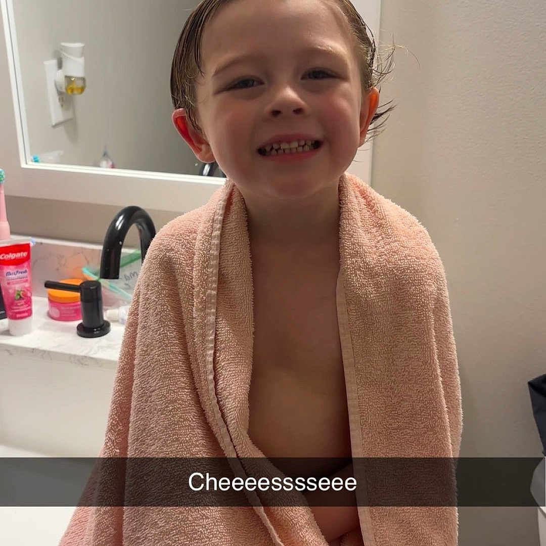 Treysen is registered to the contest to win money with this photo: bath, bathroom, child, cute, expression, face, happy, indoor, mirror, person, pink, portrait, sink, skin, smiling, snapshot, toiletries, towel, wet_hair, young