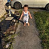 Treysen is registered to the contest to win money with this photo: barefoot, car, casual, child, clothing, concrete, daylight, garden_statue, grass, happy, house, minivan, outdoor, person, playing, running, sidewalk, smiling, sunlight, toddler