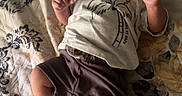Jonah joined the competition — help win amazing prizes! baby, infant, child, lying_down, quilt, bed, pacifier, diaper, clothing, shorts, shirt, patterned, indoor, cute, face, hands, feet, relaxed, young, resting