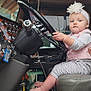Brynlee joined the competition — help win amazing prizes! accessories, baby, car, clothing, cushion, driving, face, footwear, head, homedecor, machine, person, photography, portrait, shoe, sitting, spoke, t_shirt, transportation, vehicle