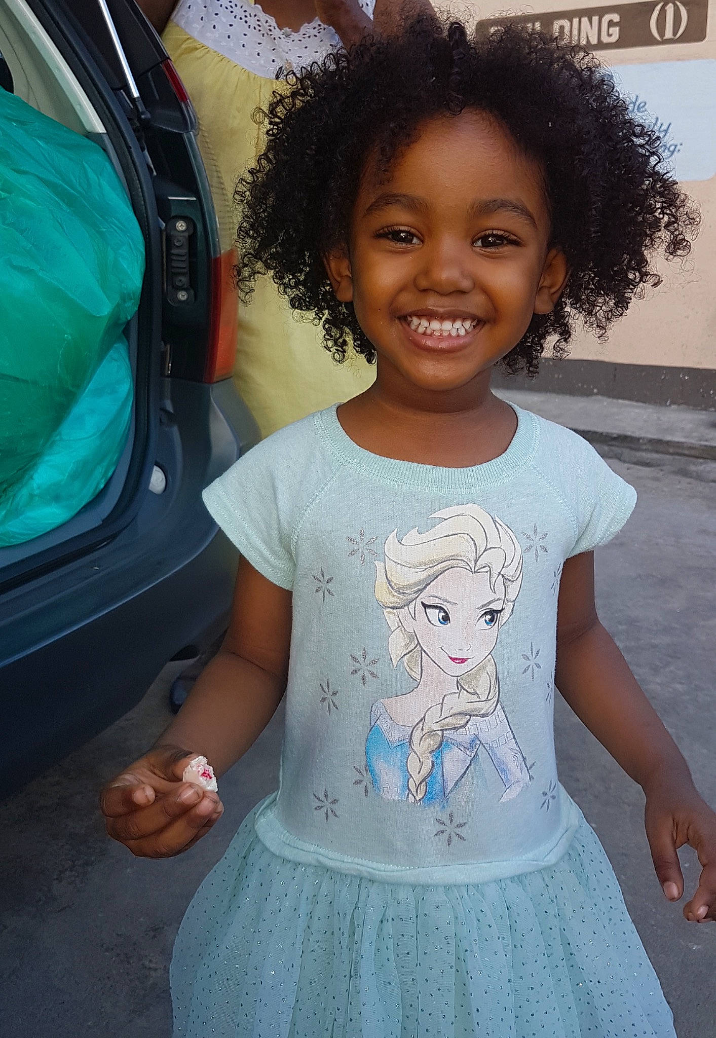 Sophie joined the competition — help win amazing prizes! automotive_exterior, automotive_lighting, baby_toddler_clothing, cool, dress, eye, face, happy, iris, joy, organ, person, pink, product, skin, sleeve, smile, standing, t_shirt, trunk