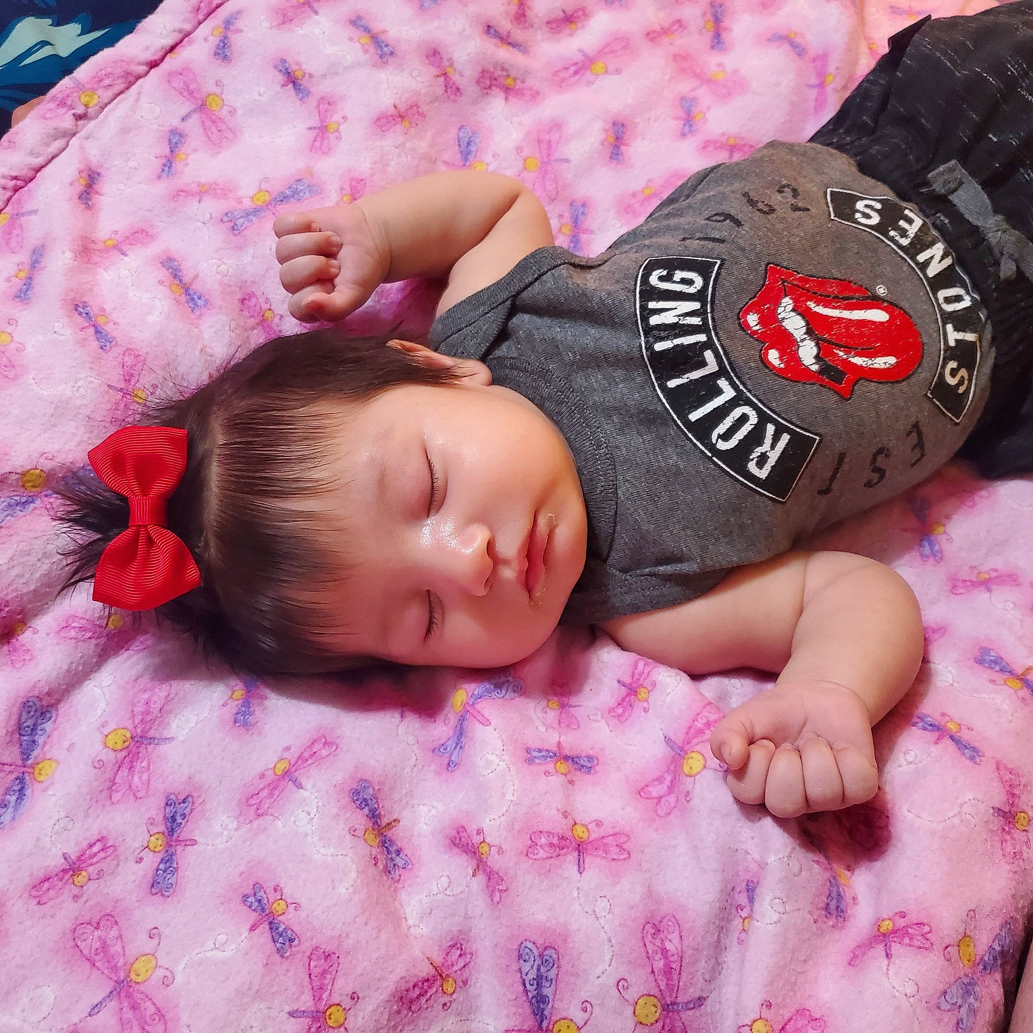 Vivienne is registered to the contest to win money with this photo: baby, baby_toddler_clothing, bedtime, cap, child, comfort, elbow, finger, hand, linens, pattern, person, pink, product, room, skin, sleeve, t_shirt, textile, toddler